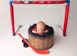 Washington Capitals newborn with hockey goal and hockey props