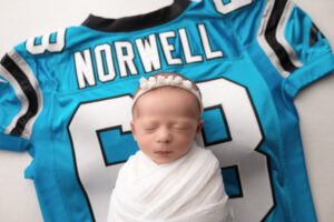 Washington Commanders baby on dad's football jersey